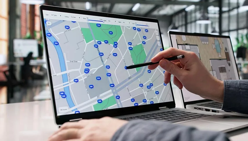 Real estate map with property price pins on a laptop screen